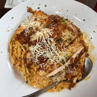 a plate of pasta with meat and cheese