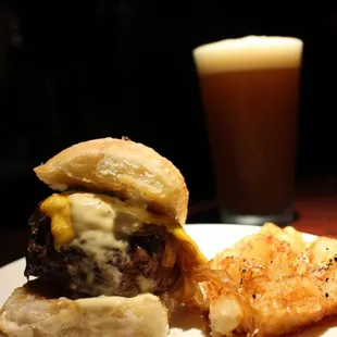 a plate of food and a glass of beer