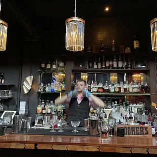 a bartender making a drink at a bar