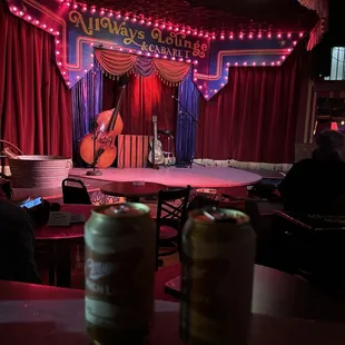 a stage with a guitar and a beer