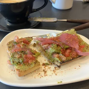 Avo toast with pickled onions, pick and tajin.