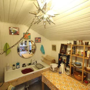 The kitchen is fully stocked and boasts a double sink and microwave/toaster oven/single burner/coffee maker/blender etc..