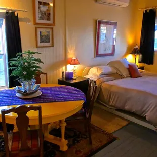 Monet yellow dining table in front room by master bed and kitchen
