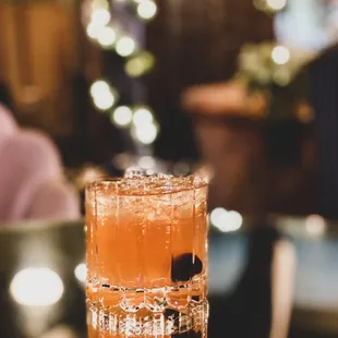 a tall glass filled with a drink