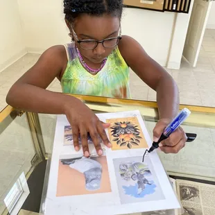 Haniah works hard to find all the paintings in the scavenger hunt.