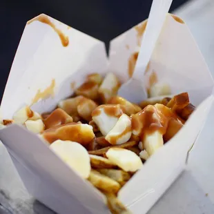 a close up of a box of poutine