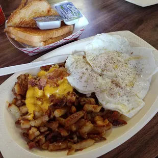 Hashbrowns (extra crispy with cheese), three eggs over medium, and white toast.