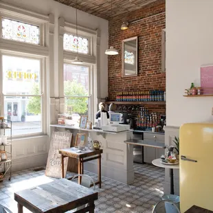 a coffee shop with a yellow refrigerator