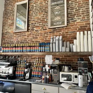 a coffee shop with a brick wall