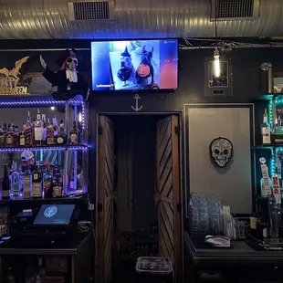 a television in the corner of the bar