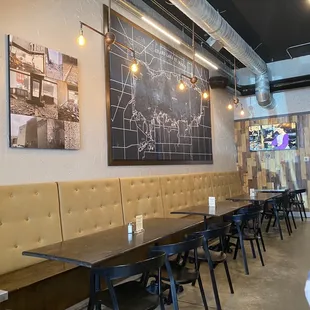 a dining area with a chalkboard on the wall