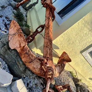 an anchor on a rock in front of a building