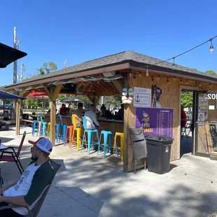 a man sitting in a chair in front of a bar