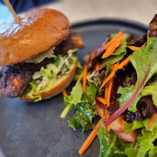 a burger and a salad on a plate