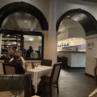 a woman sitting at a table in a restaurant