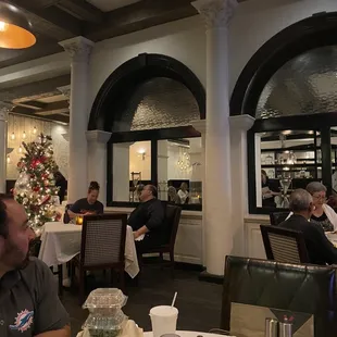 a man sitting at a table in a restaurant