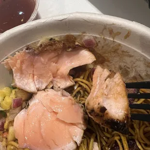 Salmon still raw on the left, cooked portion on the fork