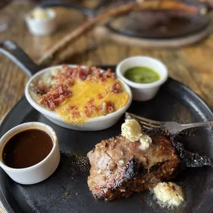 Stuffed potatoes, A piece of a tomahawk steak with garlic butter, chimichurri and a beef ajou.