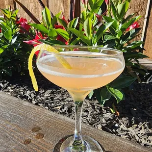 a cocktail sitting on a wooden table