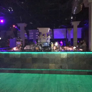 a bar with green lights