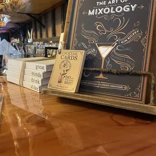 a bar with a menu and a glass of wine