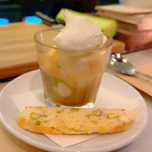 a bowl of ice cream and a piece of bread