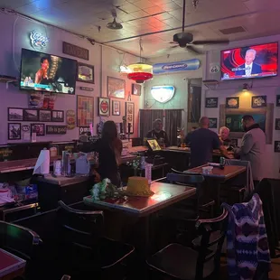 people sitting at the bar in a restaurant