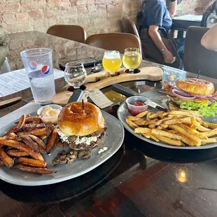 two plates of burgers and fries