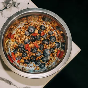 Berry Blue Parfait; yogurt mixed with honey, chia seeds, and blue spirulina, topped with fresh blueberries and our house-baked granola