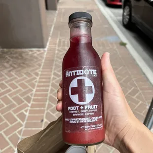 a hand holding a bottle