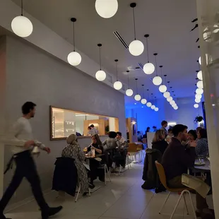 people sitting at tables in a restaurant