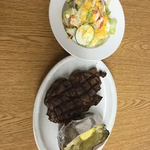 rib eye with baked potato and side salad