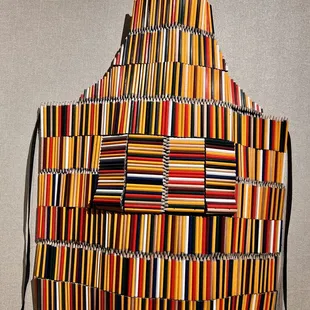 a multicolored apron hanging on a wall