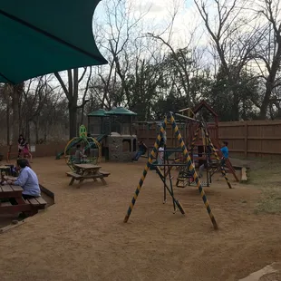 people sitting at picnic tables