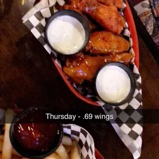 a plate of chicken wings and fries
