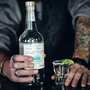 a bartender holding a bottle of alcohol