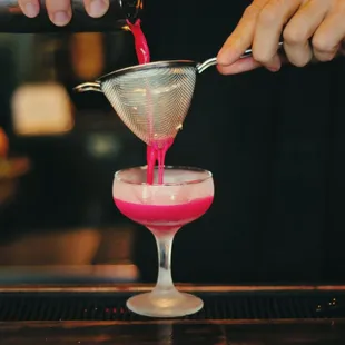 a bartender pouring a drink