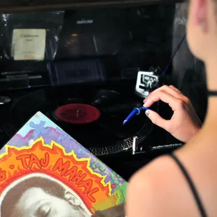 a woman writing on a record