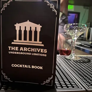 a cocktail book sitting on a bar