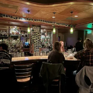 a group of people sitting at a bar