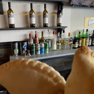 a hand holding a empanada