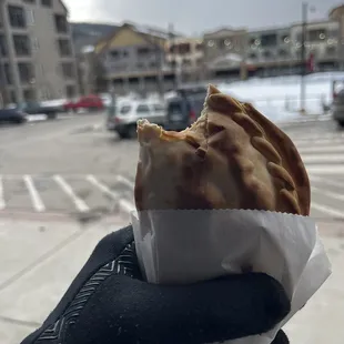 Spicy chicken empanada getting snowed on.