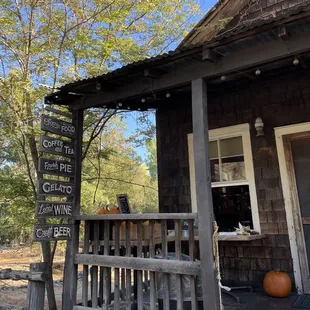 a porch with a bench and a sign