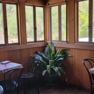 a table and chairs in front of a window