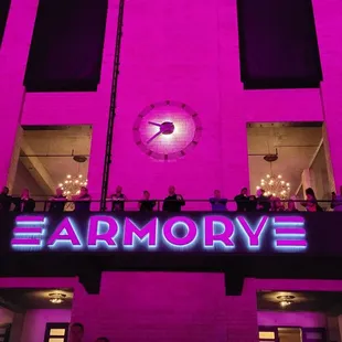 people standing on the balcony of the building
