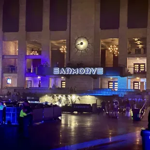 a crowd of people standing in front of a building