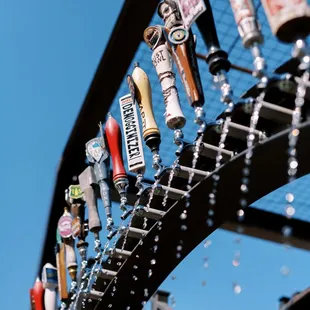 a row of beer taps on a rack