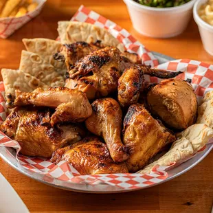 a plate of chicken wings with a side of macaroni and cheese