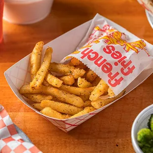 a basket of fries and broccoli