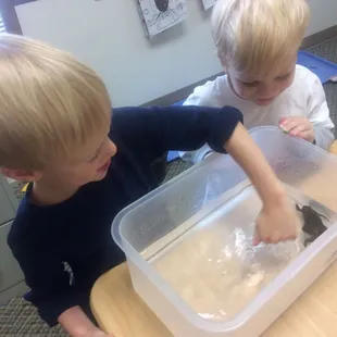 These kids are sure having fun in our preschool class touching our pet frogs!